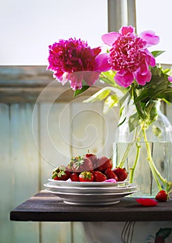 Summer rustic still life with strawberry and peony bouquet