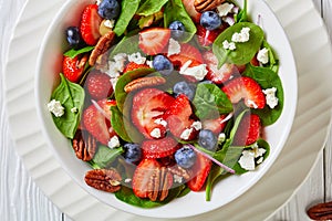 Summer salad with berries, nuts, feta cheese