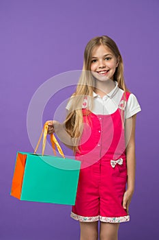 Summer sale. Girl cute teenager carries shopping bag. Kid bought clothing summer sale. Sale benefits. Seasonal sale