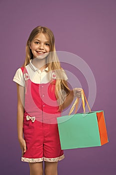 Summer sale. Girl cute teenager carries shopping bag. Kid bought clothing summer sale. Sale benefits. Seasonal sale