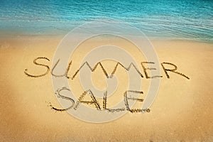 Summer sale letters on sand