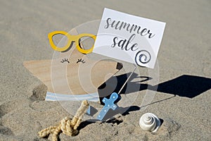 SUMMER SALE text on paper greeting card on background of funny starfish in glasses summer vacation decor promotion