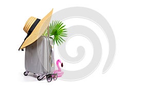 Summer sale. Travel accessories with suitcase, straw hat, palm leaves and pink flamingo in minimal trip vacation concept isolated