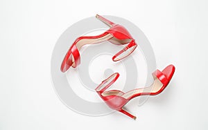 Red sandals on white background top view, flat lay, fashion, minimalism concept. Top view.