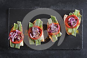 Summer sandwich prepared with fried red onion, tomato and kidney beans photo