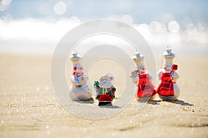 Summer Santa Claus with smowmen. Family holiday. Christmas and new year vacation concept on tropical beach.