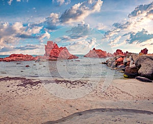 Summer scene of Cea beach with Red Rocks Gli Scogli Rossi - Faraglioni on background.