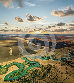 Summer scenery aerial view of winding river in beautiful valley at sunset