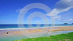 Summer sea background.Blue sky white clouds over ocean waves break on sand beach.Waves crashing against an empty beach.Sea waves a