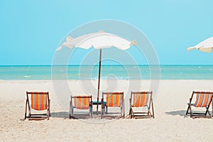 Summer sea beach empty chair umbrella with blue ocean sky for travel nature background