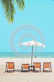 Summer sea beach empty chair umbrella with blue ocean sky for travel nature background vertical shot