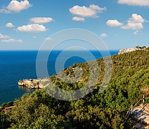 Summer sea perched Peschici town and cape Trabucco di Monte Pucci view, Gargano peninsula in Puglia, Italy