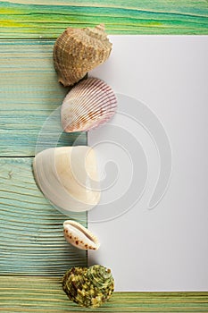 Summer sea vacation mockup background. Notebook blank page with Travel items on blue green wooden table. Sea shells