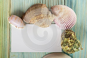 Summer sea vacation mockup background. Notebook blank page with Travel items on blue green wooden table. Sea shells