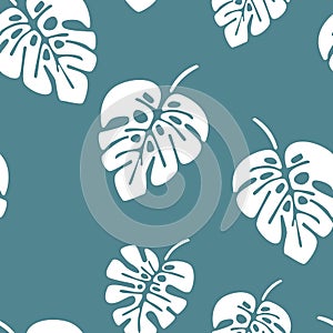 Summer seamless pattern with white monstera palm leaves on blue background