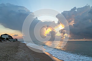 Summer seascape. Sunrise on the beach and cloudy sky