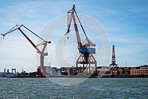 Summer seascape view of two large harbor cargo cranes against blue sky in Gothenburg Sweden.