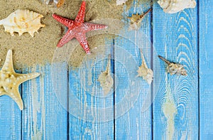 Summer season vacation wooden board with shell starfish on beach sand