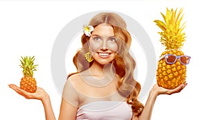 Summer selection. The girl chooses between large and small pineapple. Concept of travel. Beautiful female model with tropical