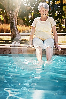 Summer, senior woman and feet in swimming pool, relax and on weekend break, happiness and calm. Stress relief, mature