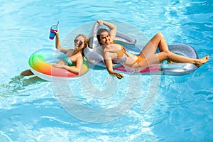 Summer sensual girls in pool. Summertime swimming pool. Summer leisure and holiday. Woman on summer vacation. Girl in