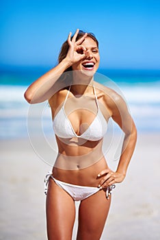 Summer shore is fun. an attractive young woman enjoying a vacation at the beach.
