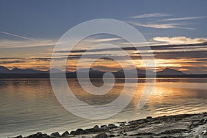 Summer skies landscape with sunset ocean mountains