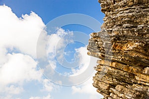 Summer sky with clouds and the rock