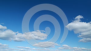 Summer sky. cumulus and stratocumulus clouds on bright blue sky. Wispy cumulus clouds pass over blue sky in nature photo