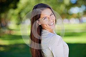 Summer smiles. Portrait of a beautiful young woman enjoying a day at the park.