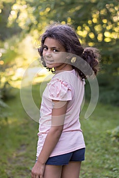 Summer. smiling girl in shorts is in the garden