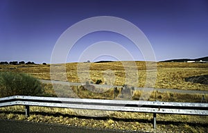 Summer in Spain along the country road many fields and cattle in the pastures