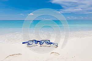 Summer sport, beach activity beach recreational banner. Diving goggles snorkel gear on white sand near sea waves