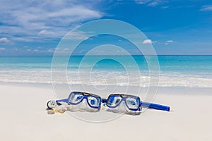 Summer sport, beach activity beach recreational banner. Diving goggles snorkel gear on white sand near sea waves