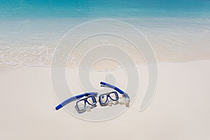 Summer sport, beach activity beach recreational banner. Diving goggles snorkel gear on white sand near sea waves