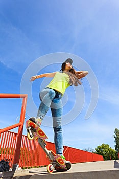 Summer sport. Cool girl skater riding skateboard