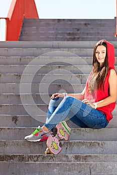 Summer sport. Cool girl skater riding skateboard