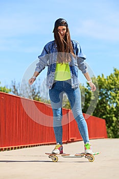Summer sport. Cool girl skater riding skateboard