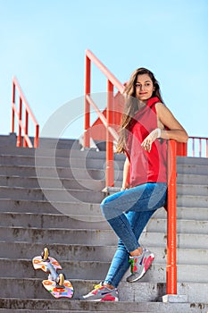 Summer sport. Cool girl skater riding skateboard