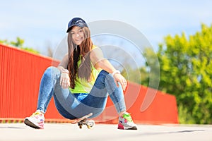 Summer sport. Cool girl skater with skateboard