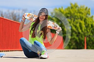 Summer sport. Cool girl skater with skateboard