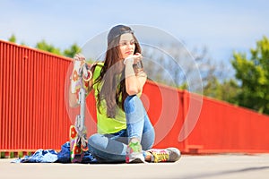 Summer sport. Cool girl skater with skateboard