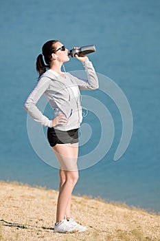 Summer sport fit woman drink water bottle