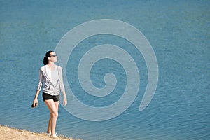 Summer sport fit woman walk on beach