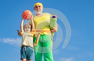 Summer sport and fun lifestyle. Sports education. Grandpa and grandson spotting. Father and child training together. I