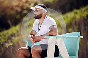 Summer, sports and a volleyball referee in a chair on the beach for authority, rules or regulations during a game