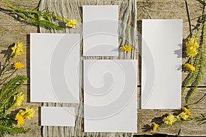 Summer stationery mockups set scene with with yellow flowers on a old wood background in rustic style and natural. Mockup card