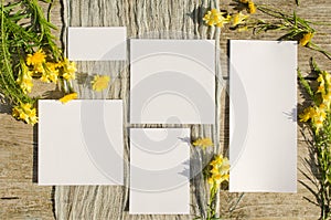 Summer stationery mockups set scene with with yellow flowers on a old wood background in rustic style and natural. Mockup card