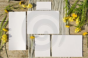 Summer stationery mockups set scene with with yellow flowers on a old wood background in rustic style and natural. Mockup card