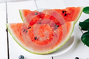 Summer still life of fresh fruit and berries on a white wooden surface